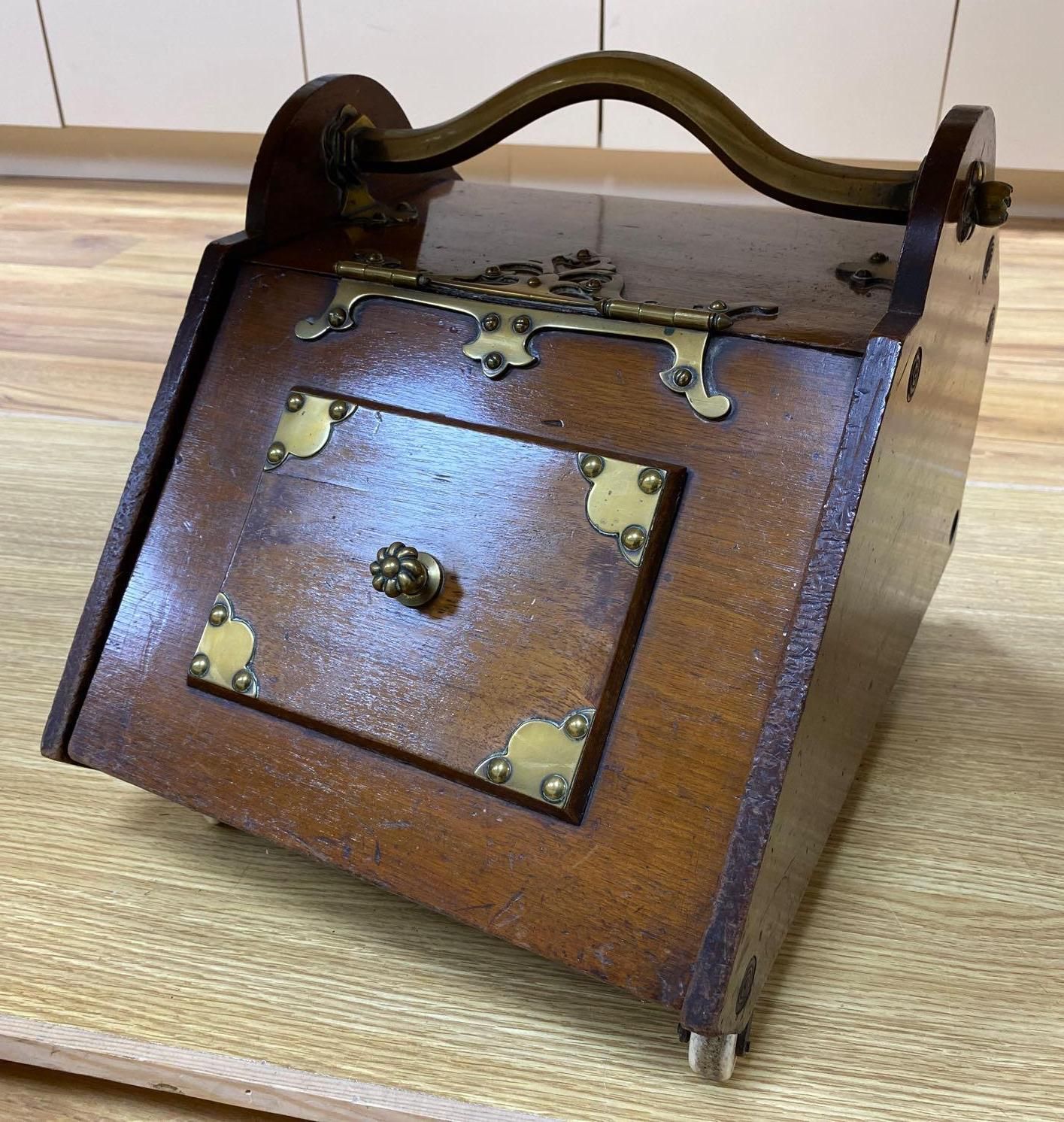 A Gothic revival walnut and brass mounted coal box on ceramic casters, 35cm wide